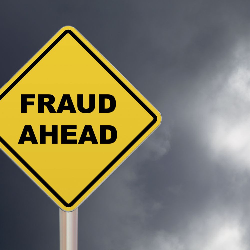 crossing-sign---fraud-ahead-697219150-4a560f15506942cb864a0c66432e4191